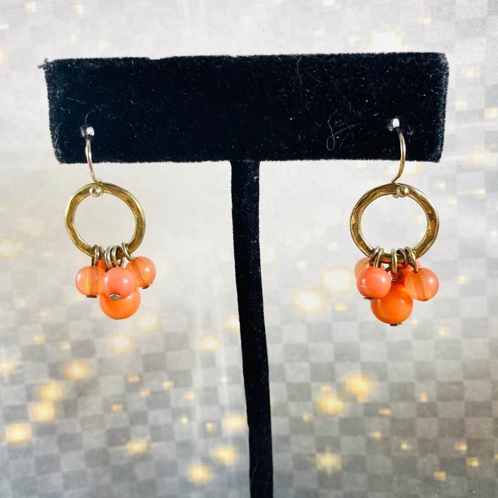 Itty Bitty little clusters of glass beads on little gold hoops.